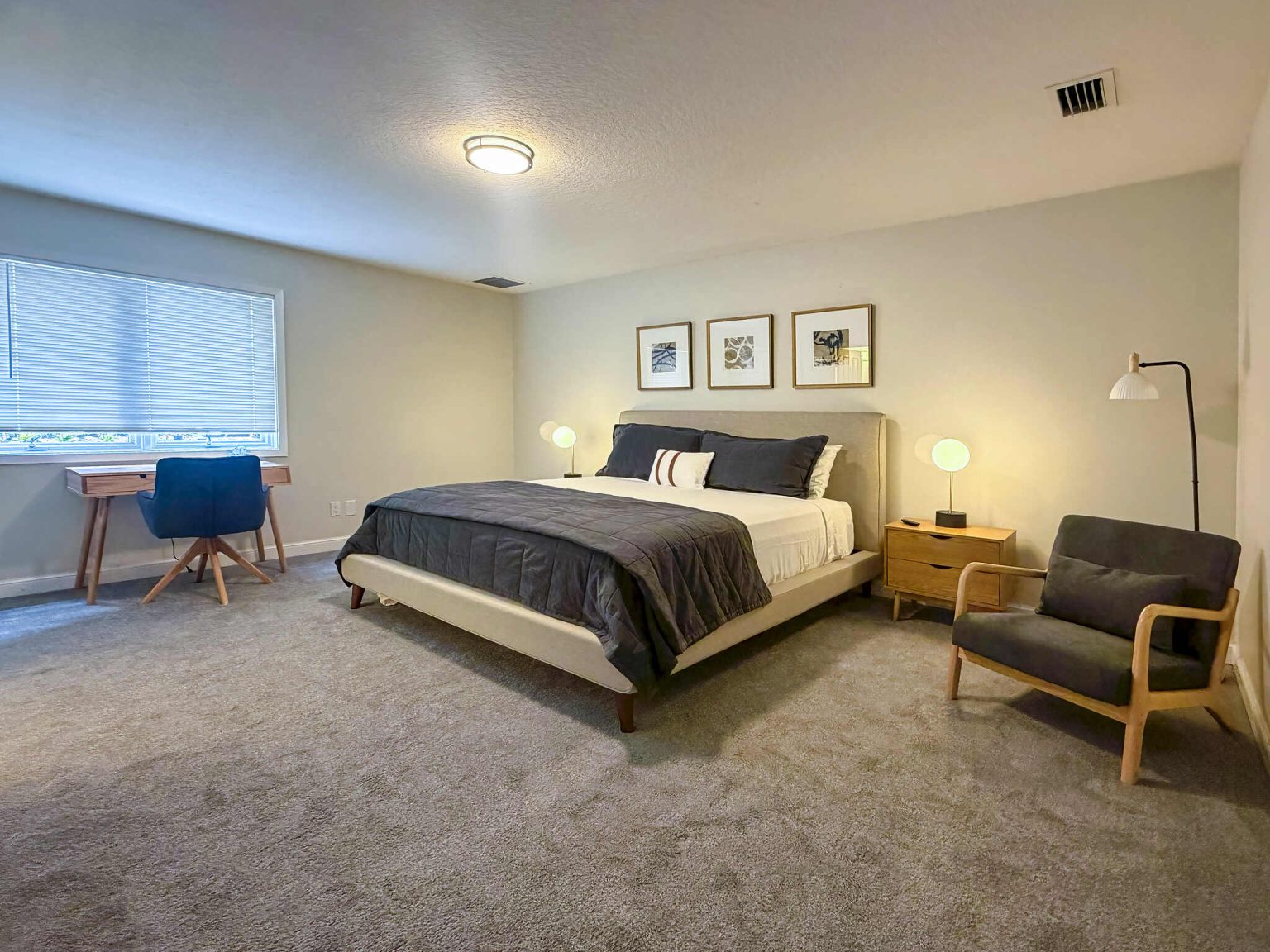 Bedroom with large bed and a few office chairs - Luxoria Recovery