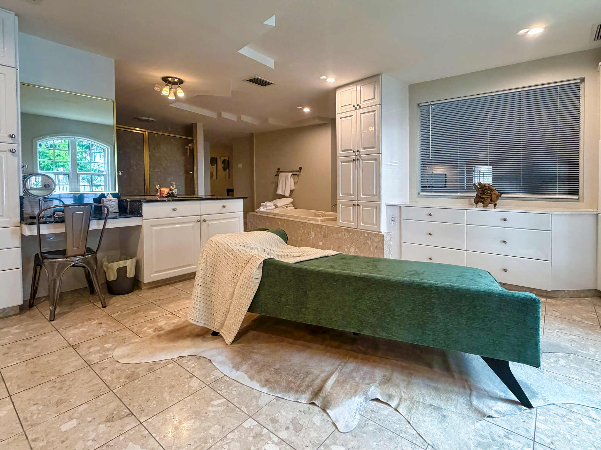Master Bathroom with a green lounge chair - Luxoria Recovery