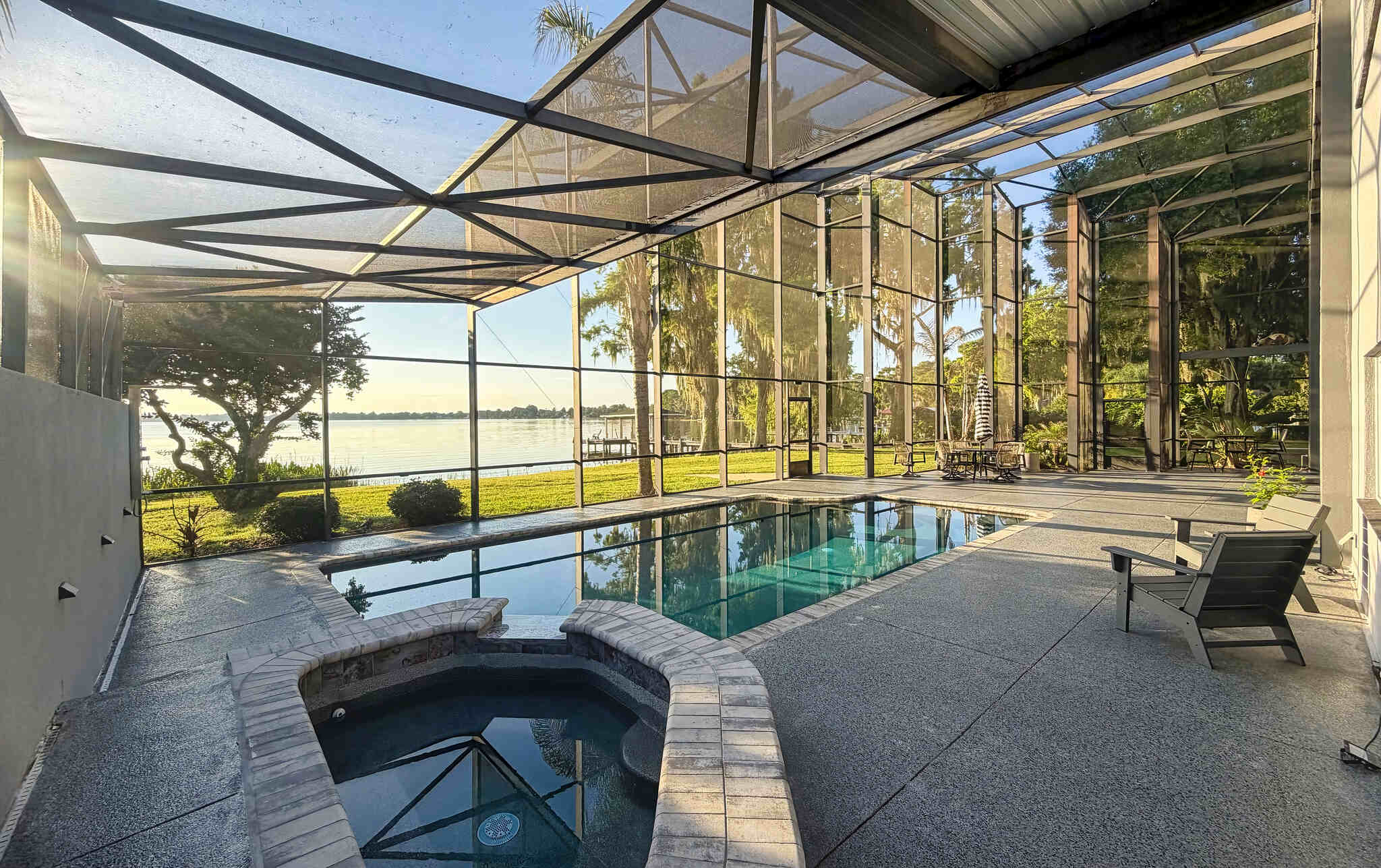 Covered Pool Area with Hot Tube and chairs - Luxoria Recovery